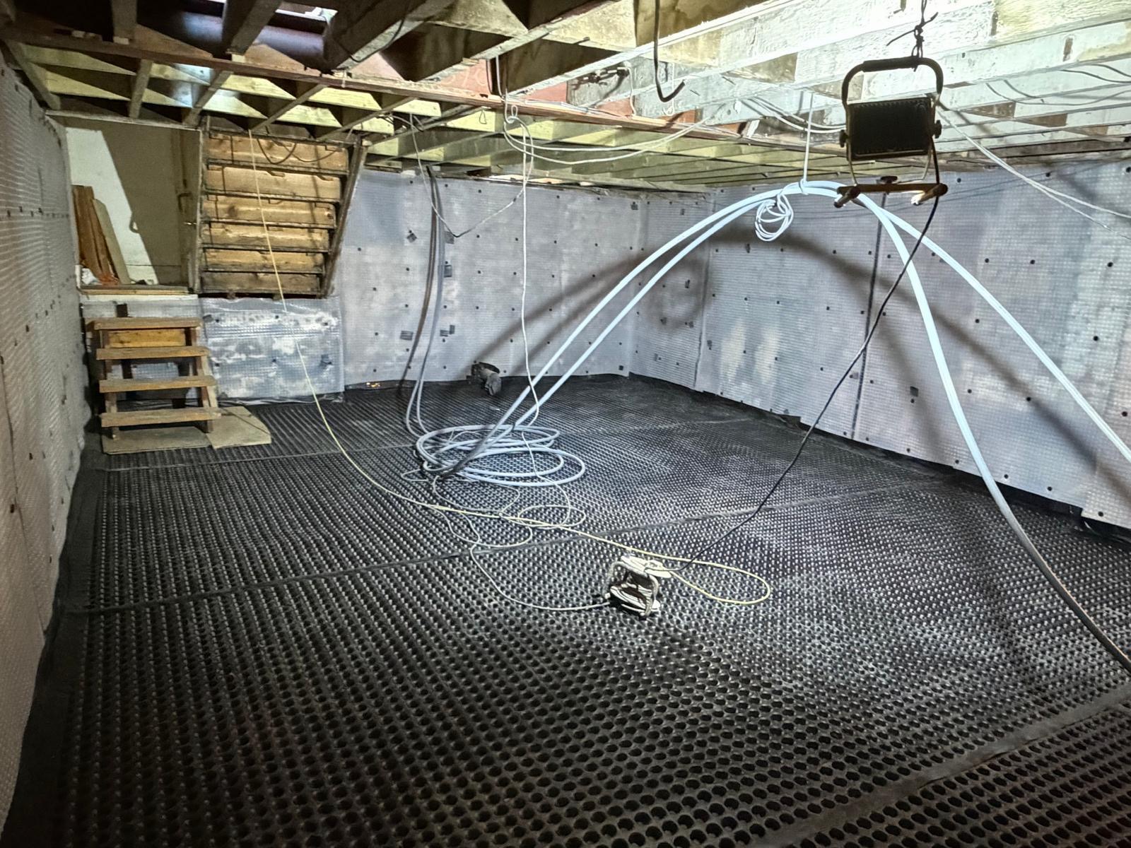 Basement ready for finishing — The drainage membrane is securely fitted before the new floor and internal finishes go in.