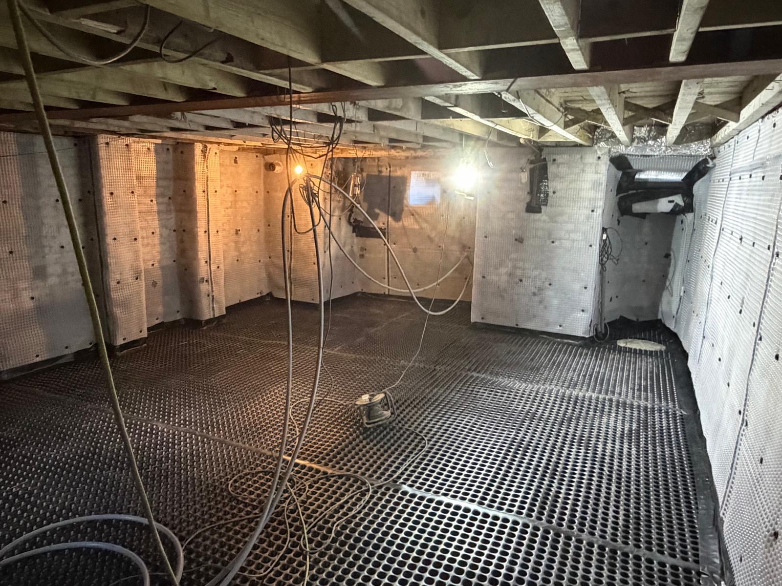 Full cavity drain system — Floor and wall membranes installed to control groundwater throughout the basement.